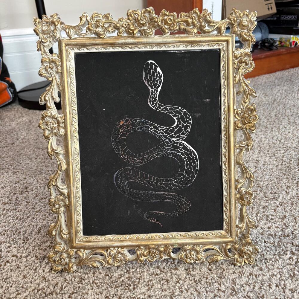 Baroque style gold color frame with serpent on matte black picture